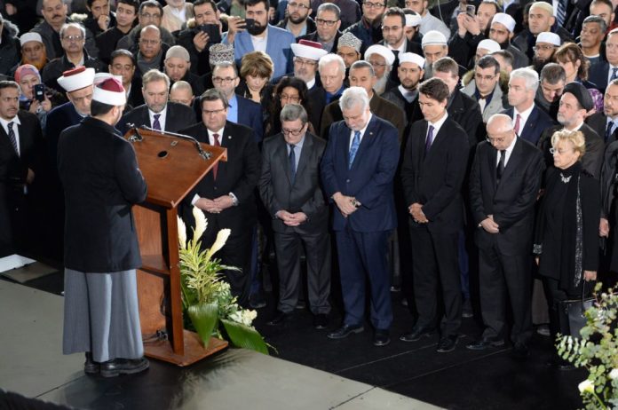 Right to Left: Justin Trudeau, Canadian Prime Minister, Quebec Premier Phillippe Couillard, Regis Labeaume, Mayor of Quebec City, and Denis Coderre, Mayor of Montreal attend the janaza for three of the Quebec Islamic Center victims along with thousands of others at the Maurice Richard Arena in Montreal. (Photo via the Toronto Star)