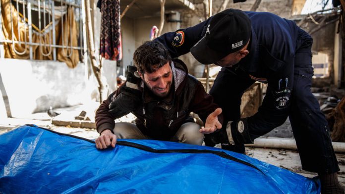 A man grieves for his loved ones, who were found dead in the rubble of a destroyed home after reported coalition airstrikes in Mosul, Iraq. Marcus Yam/LA Times