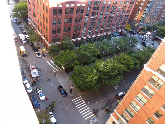 The scene of the 2017 New York City attack approximately an hour after the attack itself happened. The damaged school bus which the attacker's truck crashed into can be seen on the top left. This photo was taken from the 10th floor of Stuyvesant High School. (GH9449/Wikimedia photo)