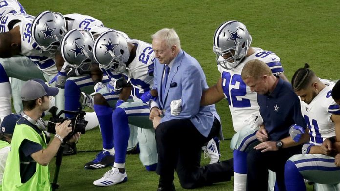 Jerry Jones, Dallas Cowboys owner, takes a knee with the team during the game against the Arizona Cardinals to show support for ending racism, police brutality and injustice. (NPR photo)