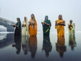 Women pray to the sun in the Yamuna river in northern India in 2019. This year, the ceremony took place in dangerous sludge and more toxic foam.